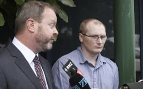 Paddy Woods listens on as his lawyer Kevin Preston makes a statement