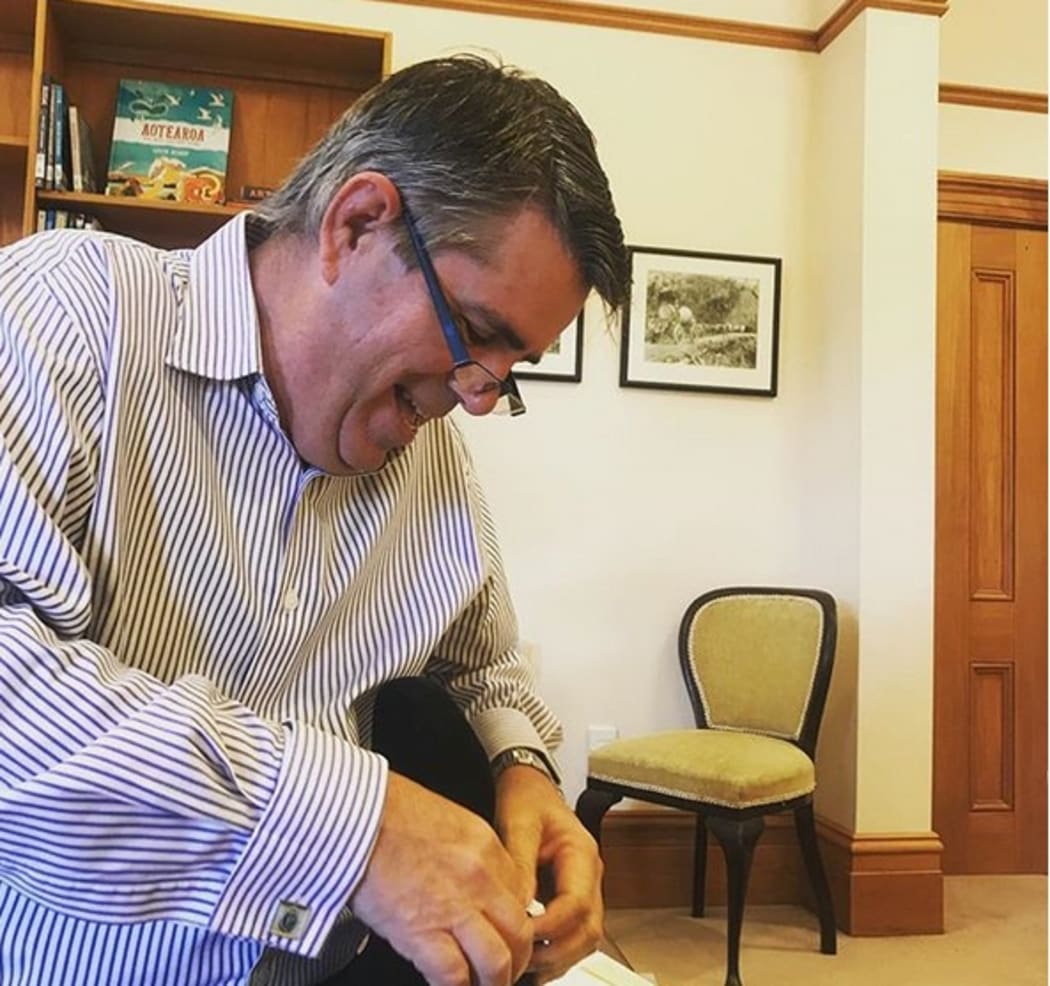 Ms Ardern posted this image of her father, Ross Ardern, helping her with her shoes a few weeks before she gave birth.