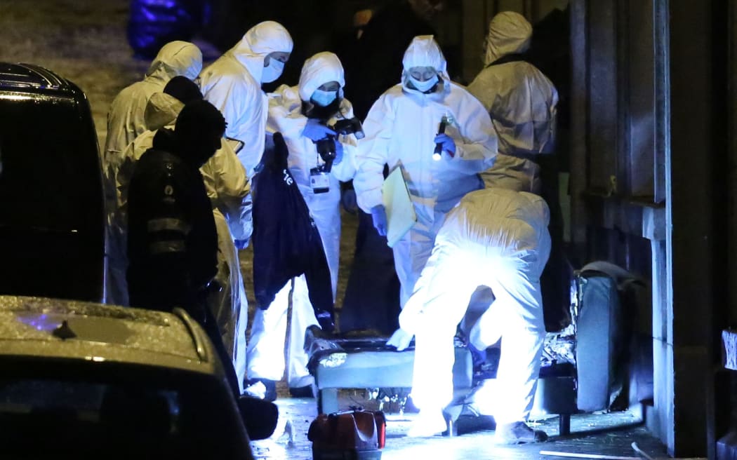 Police work into a marked out perimeter in Colline street in Verviers.