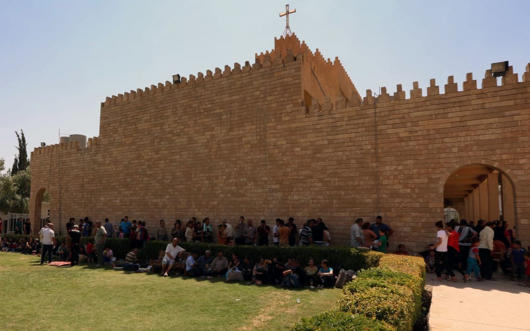 Iraqi Christians who fled the violence in the village of Qaraqush.rest at the Saint-Joseph church in Arbil.