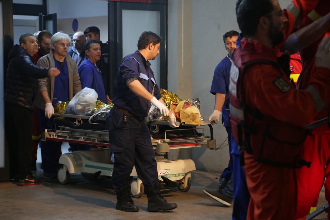 A victim of the fire at a club is transported to an emergency hospital in Bucharest