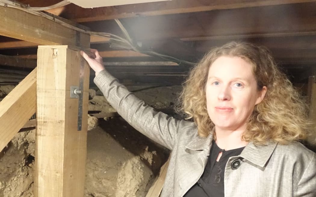 Christchurch woman Kristi Calder next to one of her foundations, which has to be repaired.
