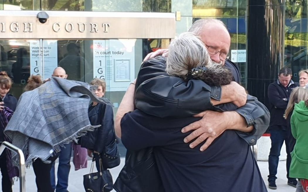 Lois Tolley's family embrace outside court today.