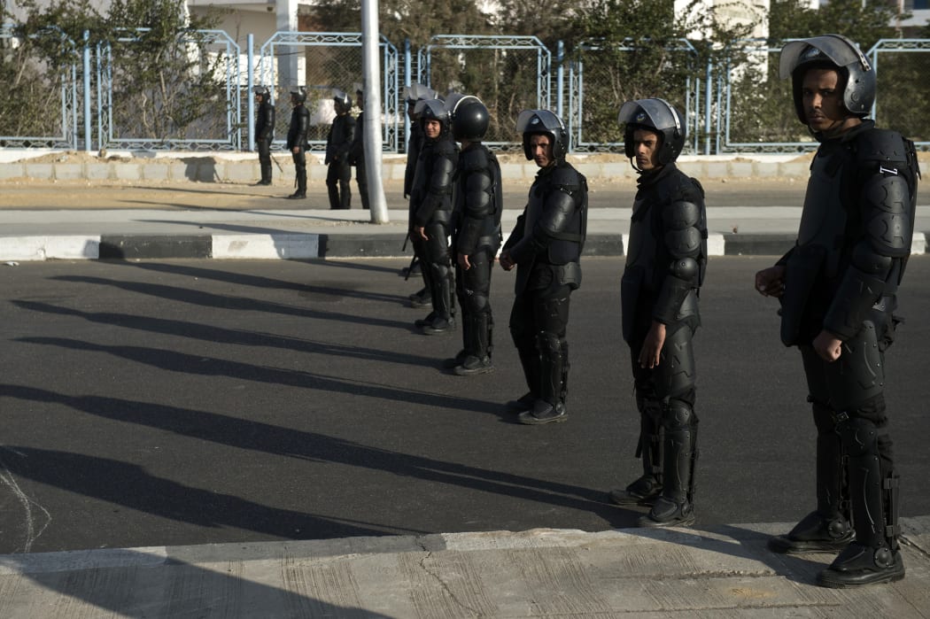 Riot police stand guard outside the National Police Academy in Cairo.