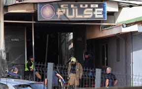 Firefighters and police officers inspect the nightclub where a fire broke out overnight in Kocani, a town some 100 kilometres east of the capital Skopje, on March 16, 2025. A fire tore through an overcrowded nightclub packed with mostly young people in North Macedonia overnight, killing 59 people, apparently after on-stage fireworks at a hip-hop concert set the venue ablaze, authorities said. Some 155 people who were injured in the inferno had been taken to hospitals across the country, 22 of them in critical condition, officials said. (Photo by Robert ATANASOVSKI / AFP)