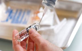 Nurse preparing an injection of morphine.