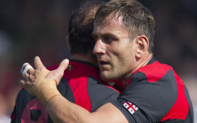 Mamuka Gorgodze of Georgia is congratulated after scoring a try against Tonga.