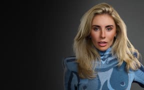 Bonnie Blue is a smooth-skinned white woman with big blonde hair and a blue top.