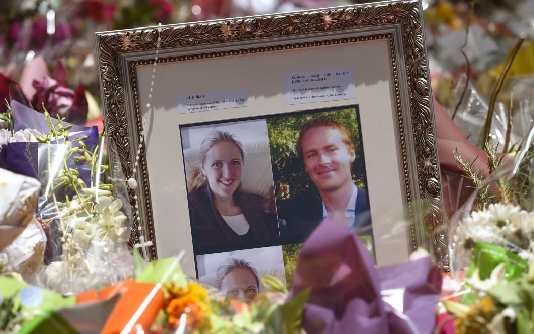 Photos showing Katrina Dawson (L) and Tori Johnson (R) sit amongst floral tributes outside the Lindt cafe in Sydney's Martin Place.