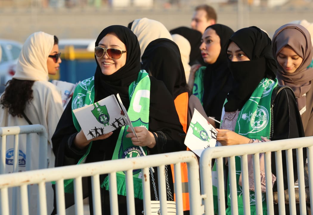 Female Saudi supporters of Al-Ahli queue at an entrance for families and women at the King Abdullah Sports City