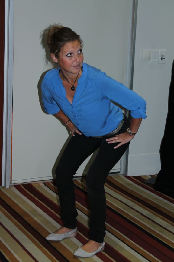Demonstrating the positioning of hips for shearing.