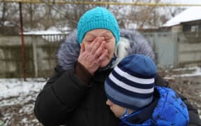 A view from Grabari village as a woman and her grandchild speaking after a shelling, in the pro-Russian separatists-controlled Donetsk, Ukraine on March 5, 2022.