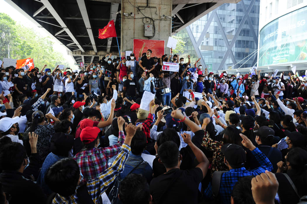 People holding placards shout slogans of anti-coup as they protest against the military coup.
