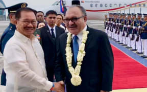 Papua New Guinea's prime minister Peter O'Neill (centre) welcomed as he arrives for a state visit to the Philippines, 16 May 2018