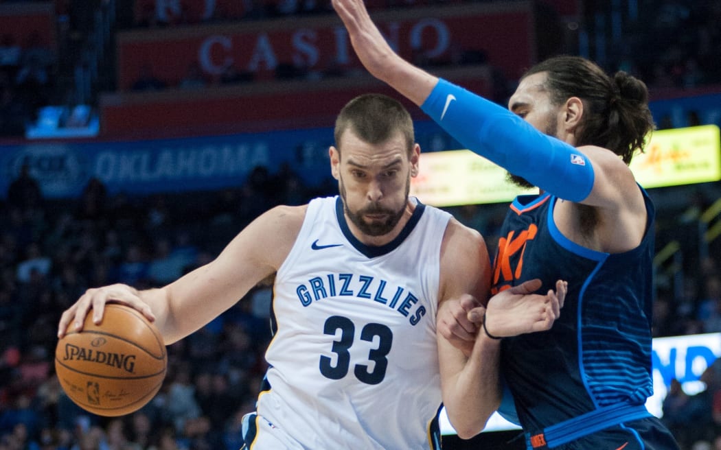Memphis Grizzlies Center Marc Gasol  driving to the basket while Oklahoma City Thunder Center Steven Adams  plays defense.