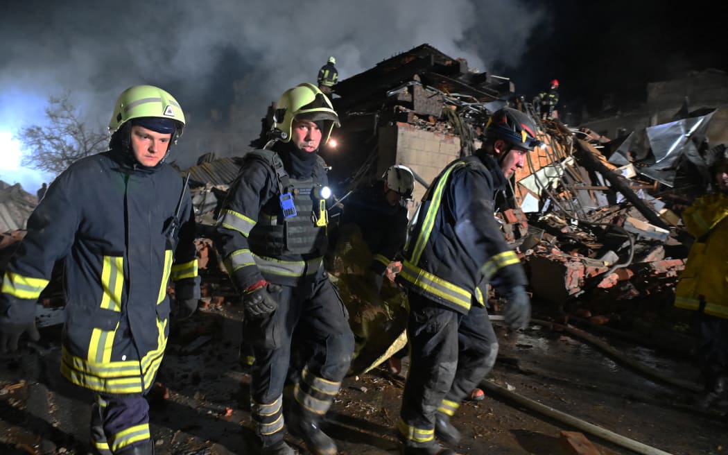 Rescue workers carry the body of a victim following a missile strike in the second largest Ukrainian city of Kharkiv.