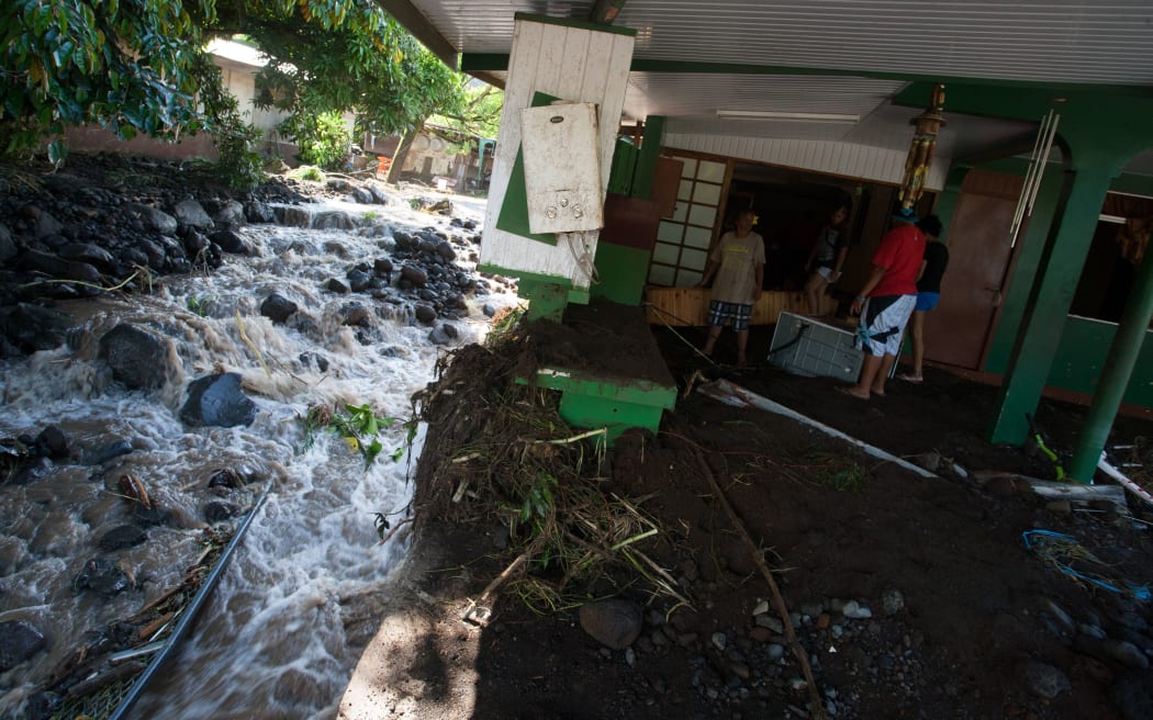 Residents inspect the damage caused by heavy rainfall and an overflow of the Ahonu river in Mahina, Tahiti, French Polynesia. December 2015.