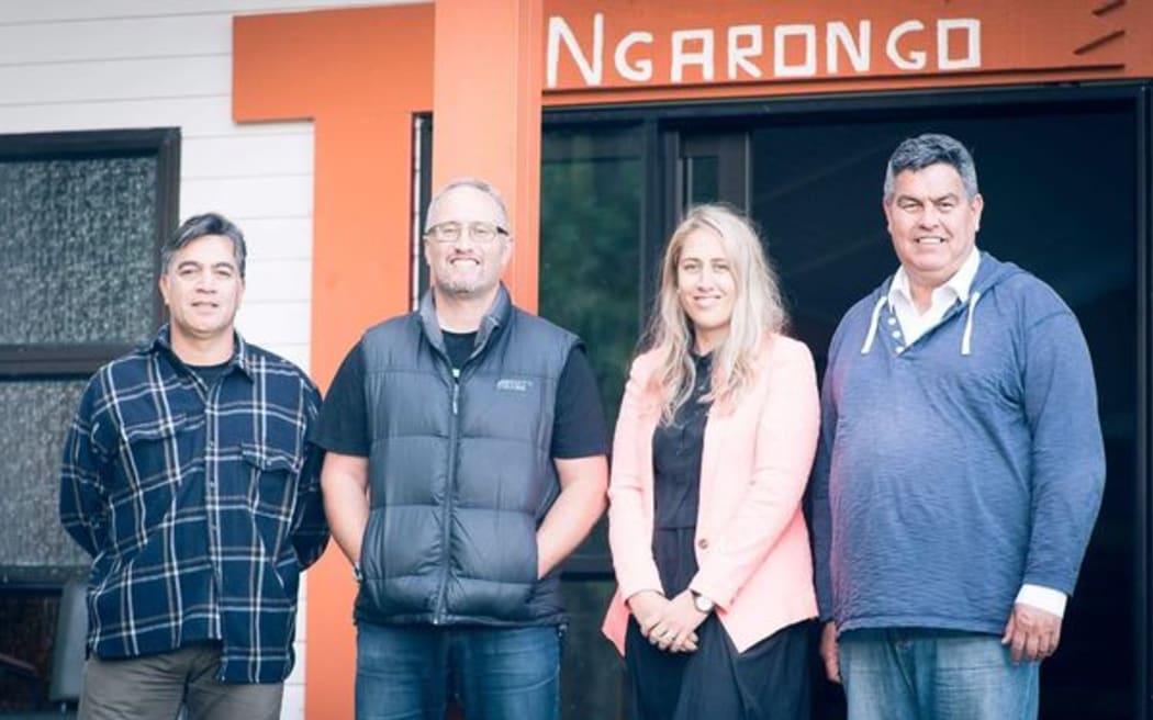 Some of Ngāti Maru's negotiators in front of the wharenui Ngarongo – (L-R) Nathan Peri, Holden Hohaia, Emma Gardiner and Anaru Marshall.