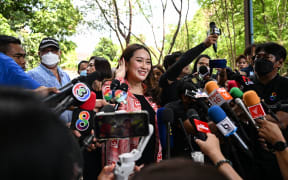 Pheu Thai Party’s prime ministerial candidate Paetongtarn Shinawatra speaks to the press after casting her ballot at a polling station during Thailand’s general election in Bangkok on 14 May 2023.