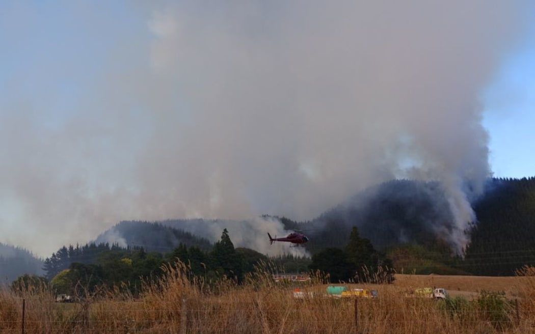 Fire fighters, helicopters and planes are battling a fire west of Blenheim.