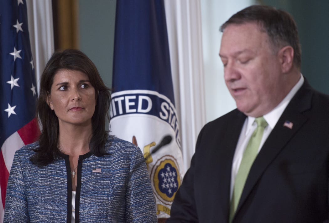 US Secretary of State Mike Pompeo speaks as US Ambassador to the United Nation Nikki Haley looks on at the US Department of State in Washington DC on June 19, 2018.
The United States announced that it is withdrawing from the UN Human Rights Council. / AFP PHOTO / Andrew CABALLERO-REYNOLDS