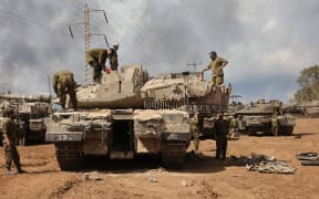 Israeli troops prepare weapons and armed vehicles near the southern city of Ashkelon on 15 October 2023.
