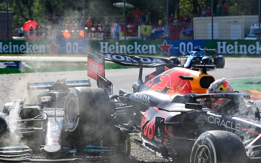 Red Bull's Dutch driver Max Verstappen (R) and Mercedes' British driver Lewis Hamilton collide during the Italian Formula One Grand Prix at the Autodromo Nazionale circuit in Monza, on September 12, 2021.