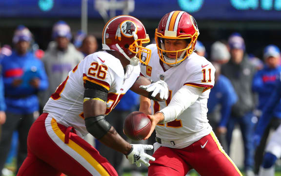 Washington Redskins quarterback Alex Smith hands the ball off to running back Adrian Peterson, 2018.