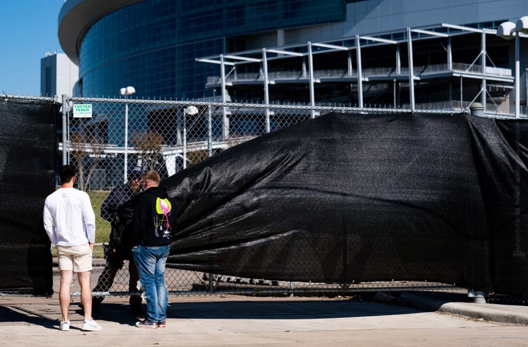 HOUSTON, TX - NOVEMBER 06: Festival patrons talk to security outside of the canceled AstroWorld festival at NRG Park on November 6, 2021 in Houston, Texas.