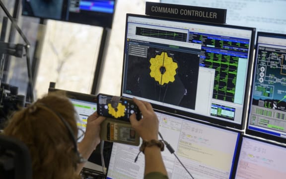 In this photo released by NASA, engineering teams at NASAs James Webb Space Telescope Mission Operations Center at the Space Telescope Science Institute in Baltimore, Maryland, monitor progress as the observatorys second primary mirror wing rotates into position, on January 8, 2022.