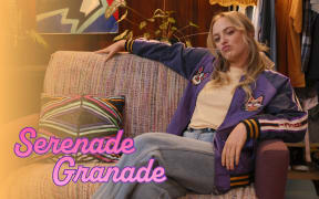 A woman reclines on a striped couch with a smirking expression, text reads "Serenade Granada"