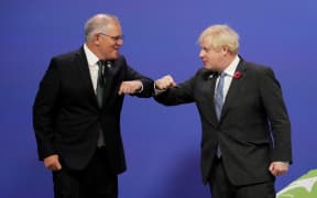 Britain's Prime Minister Boris Johnson greets Australia's Prime Minister Scott Morrison as they arrive to attend the COP26 UN Climate Change Conference in Glasgow, Scotland on November 1, 2021.