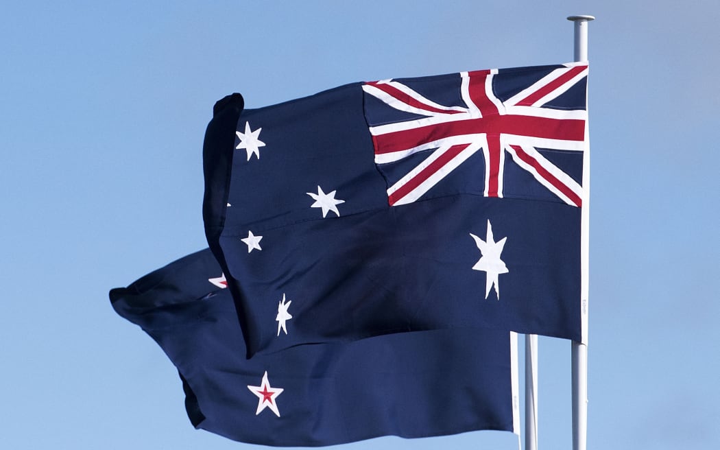 The Australian (R) and New Zealand flags fly during the dedication of the Australia ANZAC memorial at Pukeahu National War Memorial Park in Wellington, New Zealand on APRIL 20, 2015.   AFP PHOTO / MARTY MELVILLE (Photo by Marty MELVILLE / AFP)