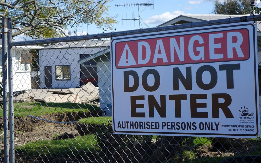 Four months after the floods, residents are still prevented from reaching their damaged homes.