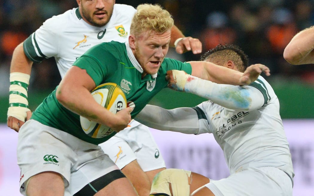 Ireland centre Stuart Olding fends off a tackle.