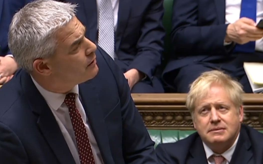 A video grab shows Britain's Prime Minister Boris Johnson (R) reacting as Britain's (Brexit Minister) Stephen Barclay speaking during the conclusion of proceedings of the European Union (Withdrawal Agreement) Bill, in the House of Commons  on January 9, 2020.