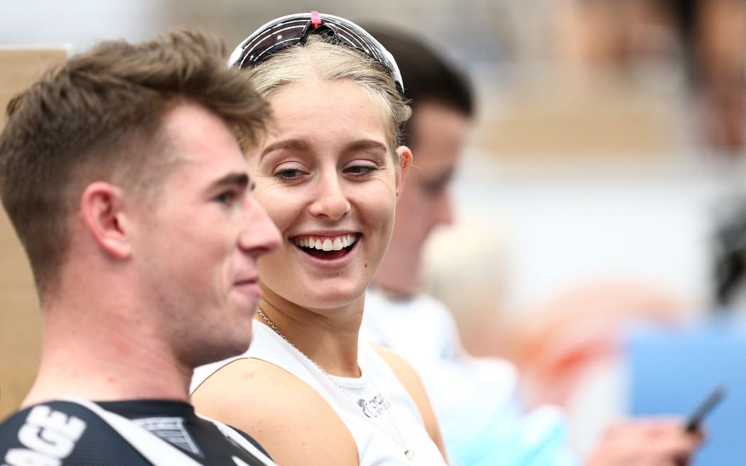 A photo of Olivia Podmore laughing with fellow cyclist Sam Dakin