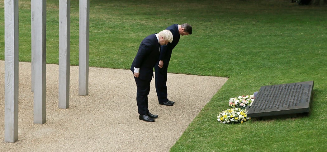 British Prime Minister David Cameron, right, and London Mayor Boris Johnson lay wreaths in London's Hyde Park in memory of the 52 victims of the 7/7 London attacks.