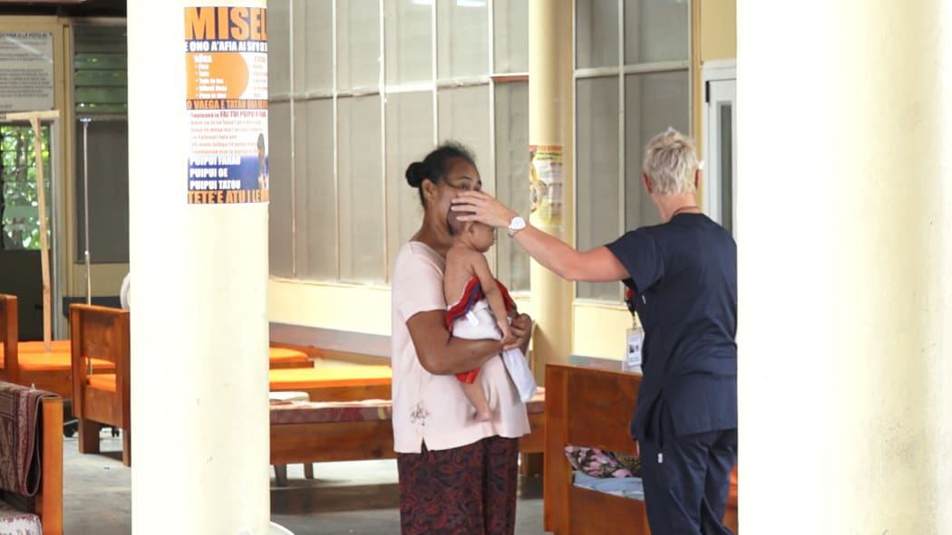 A baby who has measles at a clinic run by New Zealand doctors.