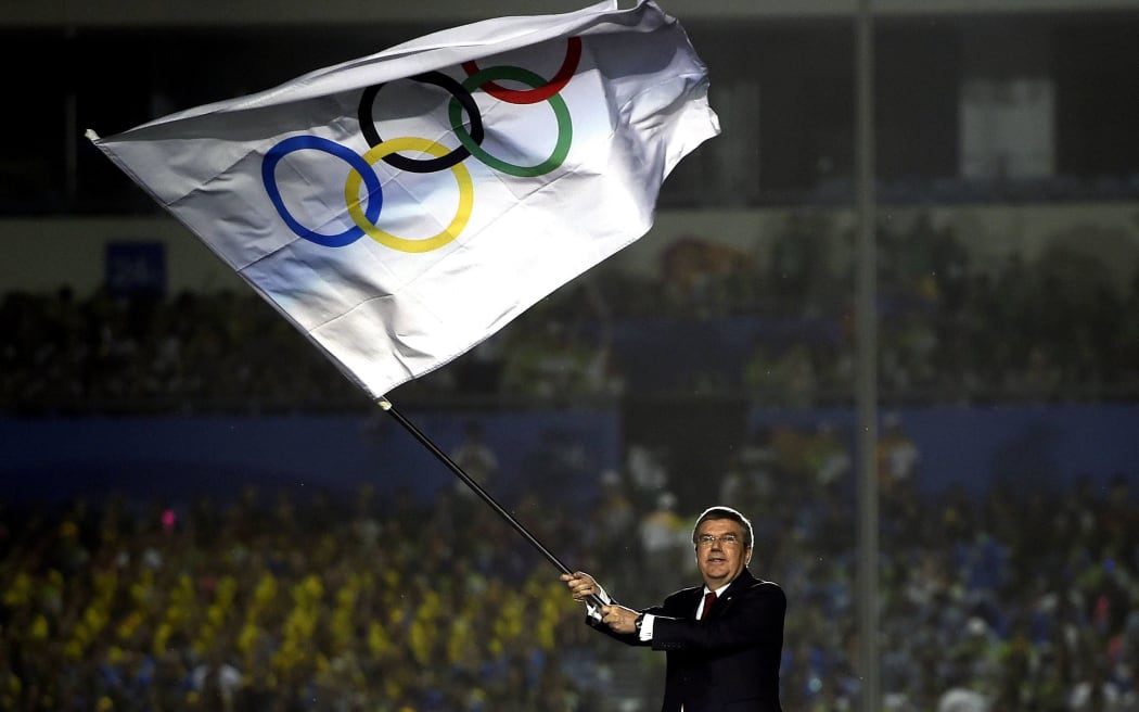 The President of the International Olympic Committee Thomas Bach waves the Olympic Flag during the closing ceremony of Nanjing 2014 Youth Olympic Games in Nanjing, capital of east Chinas Jiangsu Province, Aug. 28, 2014.
