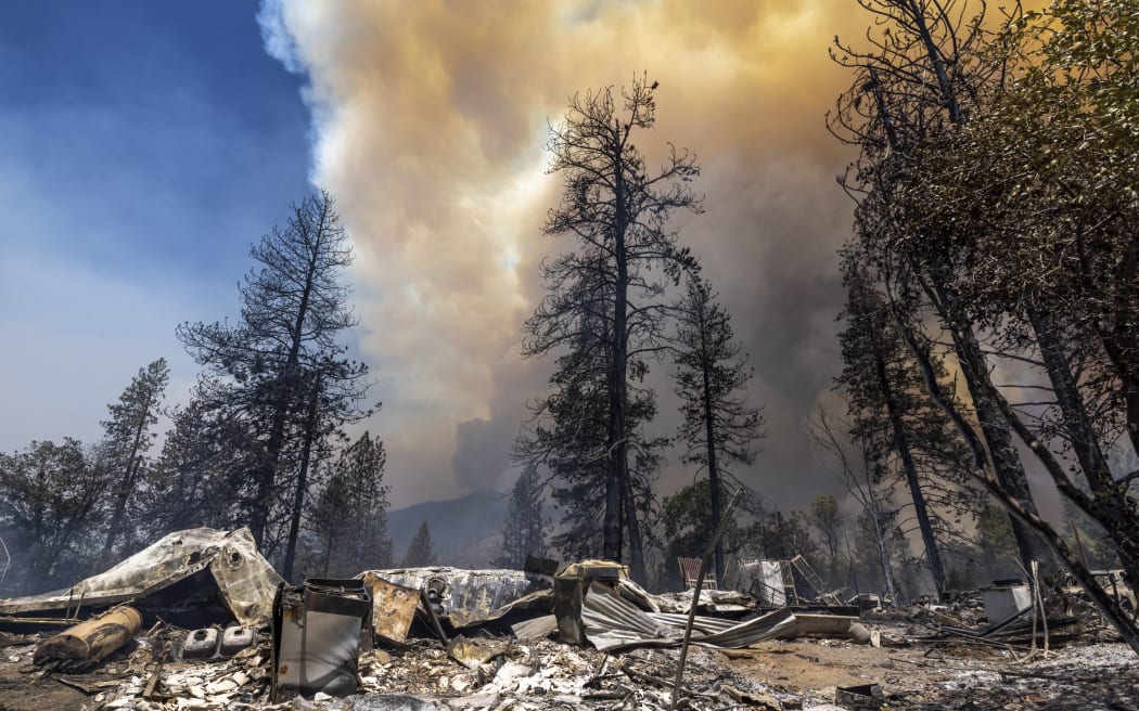 Destroyed property is left in its wake as the Oak Fire chews through the forest near Midpines, northeast of Mariposa, California, on July 23, 2022. - The fire is burning west of Yosemite National Park where the Washburn Fire has threatened the giant sequoia trees of the Mariposa Grove. (Photo by DAVID MCNEW / AFP)