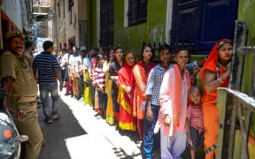 Indian voters queue at a polling station to cast their votes in Varanasi in Uttar Pradesh state on May 19 during the seventh and final phase of India's general election.