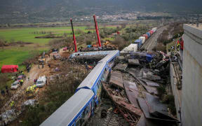 Police and emergency crews search the debris of a crushed wagon after a train accident in the Tempi Valley near Larissa, Greece on 1 March 2023. - At least 36 people were killed after a collision between two trains caused a derailment near the Greek city of Larissa late at night on February 28, 2023, authorities said.