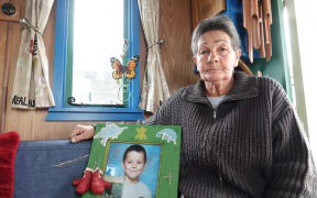 Robyn Dandy sits inside her travelling wagon with a photo of her grandson, Kahn Petch.