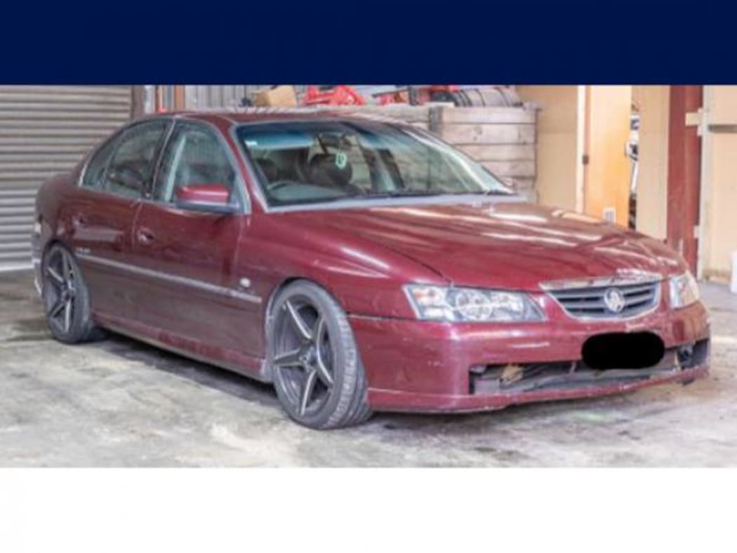 An image of the maroon Holden Commodore police are seeking sightings of.