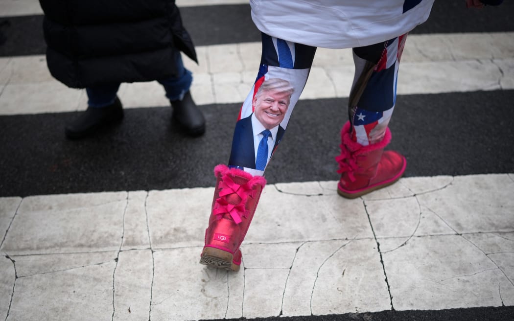WASHINGTON, DC - JANUARY 19: A woman wears Donald Trump leggings on January 19, 2025 in Washington, DC. U.S. President-elect Donald Trump and Vice President-elect JD Vance will be sworn in on January 20.   Christopher Furlong/Getty Images/AFP (Photo by Christopher Furlong / GETTY IMAGES NORTH AMERICA / Getty Images via AFP)