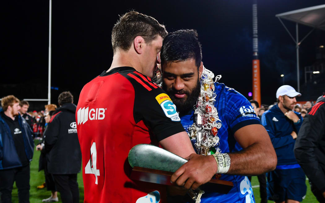Scott Barrett of the Crusaders congratulates Akira Ioane after playing 100 games for the Blues, 2023