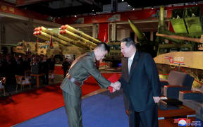 North Korean leader Kim Jong Un presenting a commendation award during the defence development exhibition "Self-Defence-2021" at the Three-Revolution Exhibition House in Pyongyang.