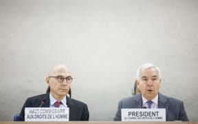 High Commissioner for Human Rights Volker Turk listens as UN Human Rights Council President Federico Villegas adresses the assembly during a special session of the UN Human Rights Council on the situation in Iran, in Geneva.