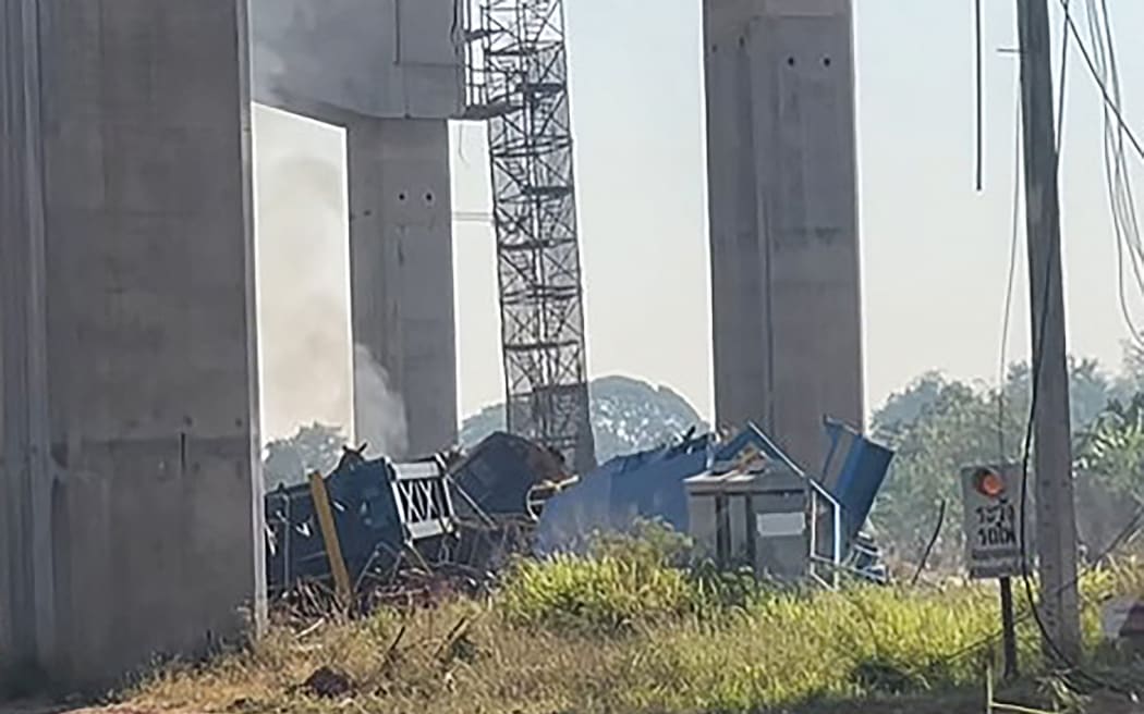This screen grab made from UGC handout video footage courtesy of Facebook user Smith Mikle taken and released on January 14, 2026 shows the wreckage of a train that crashed after a construction crane collapsed in Thailand's Nakhon Ratchasima province. A crane at an under-construction high-speed rail line in Thailand collapsed onto a passenger train on January 14, causing it to derail and killing at least 22 people, local authorities said. (Photo by Handout / Courtesy of Facebook user Smith Mikle / AFP) / NO USE AFTER JANUARY 24, 2026 04:53:32 GMT - NO USE AFTER JANUARY 24, 2026 04:53:32 GMT - RESTRICTED TO EDITORIAL USE – MANDATORY CREDIT «  AFP PHOTO / COURTESY OF FACEBOOK USER SMITH MIKLE » - NO MARKETING NO ADVERTISING CAMPAIGNS – DISTRIBUTED AS A SERVICE TO CLIENTS - NO ARCHIVE /